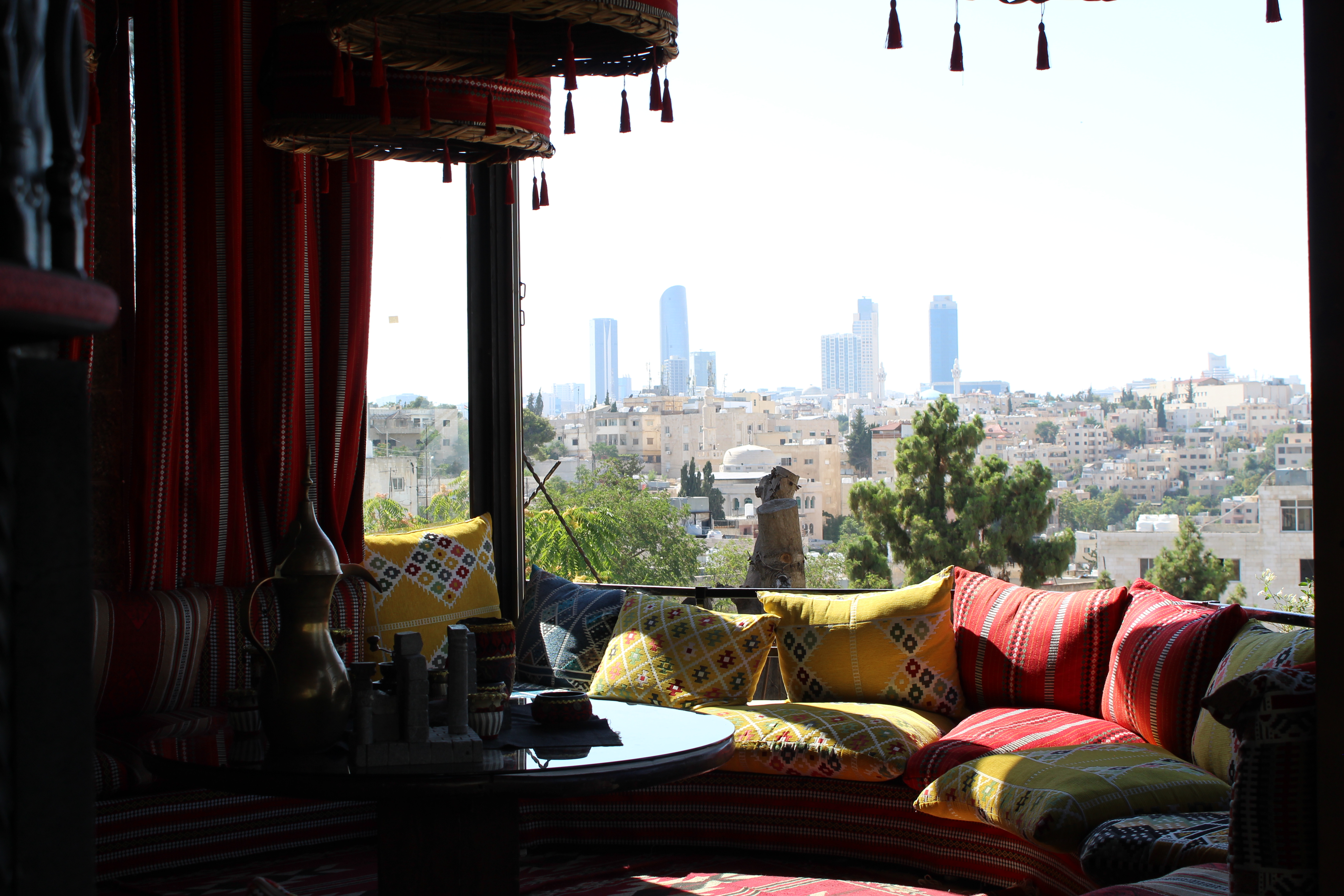 Traditional café interior on Rainbow Street Amman with colourful cushions and city view