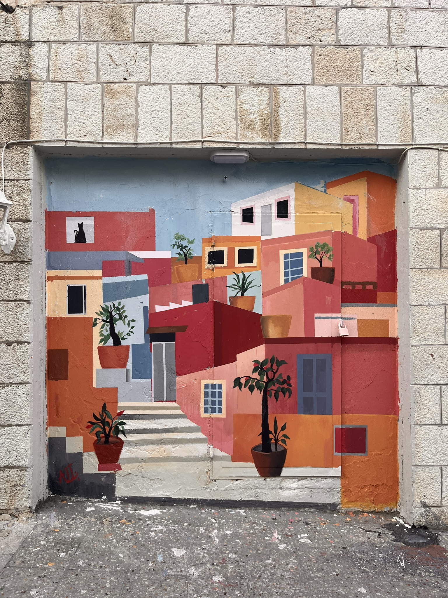 Colourful wall mural depicting a Mediterranean street scene in Amman Jordan